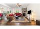 Inviting living room with hardwood floors, a stone fireplace, a ceiling fan, and an area rug at 1828 Wellspring Ct, Graham, NC 27253