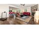 Spacious open-concept living room with hardwood floors, a fireplace, and seamless transition to the kitchen and dining area at 1828 Wellspring Ct, Graham, NC 27253