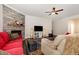 Comfortable living room features a stone fireplace, hardwood floors, and a ceiling fan for added comfort at 1828 Wellspring Ct, Graham, NC 27253