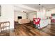 Open-concept living space with hardwood floors connecting the living room, dining area, and kitchen island at 1828 Wellspring Ct, Graham, NC 27253