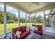 Enjoy this screened in porch furnished with outdoor seating with a ceiling fan and a view of the backyard at 1828 Wellspring Ct, Graham, NC 27253