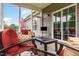 Bright sunroom with comfortable seating and glass windows to the outside at 1828 Wellspring Ct, Graham, NC 27253