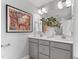 Bathroom vanity with double sinks, white countertops, framed mirror, and modern lighting at 1928 Fishamble # 24, Fuquay Varina, NC 27526