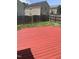 Backyard features a large painted patio deck and a wood fence at 2001 Ballston Pl, Knightdale, NC 27545