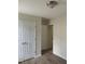 Bright bedroom with closet, neutral walls, and light-colored wood-look floors at 2001 Ballston Pl, Knightdale, NC 27545
