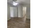 Well lit bedroom featuring ceiling fan, doors leading to bathroom, and wood-look flooring at 2001 Ballston Pl, Knightdale, NC 27545