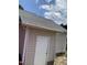 Siding exterior with a white door, gutters, and a partial view of the roof at 2001 Ballston Pl, Knightdale, NC 27545