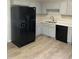 Well-equipped kitchen with gray cabinetry, black appliances, and ample counter space at 2001 Ballston Pl, Knightdale, NC 27545