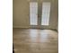Bright living room featuring wood-look flooring and sliding glass doors leading to the backyard at 2001 Ballston Pl, Knightdale, NC 27545
