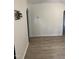 View of living room with light walls and floors, with a wall-mounted tv attachment at 2001 Ballston Pl, Knightdale, NC 27545