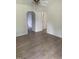 Spacious room with neutral walls, light wood floors, and open doorways at 2001 Ballston Pl, Knightdale, NC 27545