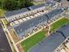New townhomes with manicured lawns, sidewalks, and convenient parking spaces create a welcoming community at 2006 Nola Ln, Durham, NC 27713