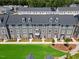 An aerial view highlights the townhome community, with lush green spaces between the units at 2006 Nola Ln, Durham, NC 27713