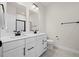 Bathroom with double sink vanity, large mirrors, modern lighting, and tiled floor at 2006 Nola Ln, Durham, NC 27713