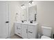 Bathroom featuring a double sink vanity, modern lighting, black hardware, and tiled floors at 2006 Nola Ln, Durham, NC 27713