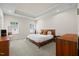 Well-lit bedroom with neutral decor, a large bed, and two large windows at 2006 Nola Ln, Durham, NC 27713