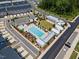 Aerial view of a community pool area and playground offers plenty of seating and shade at 2006 Nola Ln, Durham, NC 27713