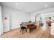 Open dining area with a wooden table, bench, adjacent to staircase, and plenty of natural light at 2006 Nola Ln, Durham, NC 27713