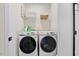 Laundry room featuring front load washer/dryer set, ample shelving for storage, and clean design at 2006 Nola Ln, Durham, NC 27713