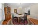 Formal dining room with elegant chandelier, hardwood floors, and decorative rug at 2127 Somers Ave, Burlington, NC 27215