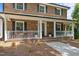 Inviting front porch with white railings and space for seating and decor at 2127 Somers Ave, Burlington, NC 27215