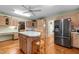 Bright kitchen featuring wood cabinets, a central island, stainless steel fridge at 2127 Somers Ave, Burlington, NC 27215