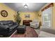 Cozy living room with a piano, plush seating, and a window for natural light at 2127 Somers Ave, Burlington, NC 27215