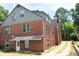 Rear view of the home showcasing brick architecture and an outdoor access road at 2210 Hope St, Raleigh, NC 27607
