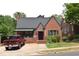 Charming brick home featuring a classic design, complemented by lush greenery and a well-maintained yard at 2210 Hope St, Raleigh, NC 27607