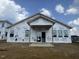 Home under construction with Tyvek wrap, highlighting the framework for the windows and doors at 223 Norman Ave, Lillington, NC 27546