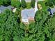 Overhead view of the backyard showing a deck, covered patio, and lush greenery surrounding the property at 225 Midenhall Way, Cary, NC 27513