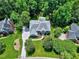 Birds eye view of brick home showing the property lines, surrounding trees, and manicured lawn at 225 Midenhall Way, Cary, NC 27513