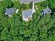 Aerial shot of the backyard, showcasing the deck, patio, and the surrounding trees and lawn at 225 Midenhall Way, Cary, NC 27513