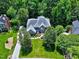 Aerial view showcasing the beautiful brick home surrounded by lush greenery and a well-maintained yard at 225 Midenhall Way, Cary, NC 27513