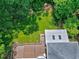 Aerial view of the backyard with lush green lawn and roof, with an outdoor deck and covered porch at 225 Midenhall Way, Cary, NC 27513