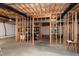 Unfinished basement with exposed framing, concrete floor, open spaces, and visible utilities at 225 Midenhall Way, Cary, NC 27513