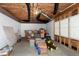 Unfinished basement featuring concrete floors, white-painted brick, and exposed wooden ceiling beams and duct work at 225 Midenhall Way, Cary, NC 27513