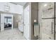 Elegant bathroom boasts a spacious shower, marble floors, and a double door leading to the bedroom at 225 Midenhall Way, Cary, NC 27513