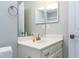 Bathroom with a white sink, a mirror cabinet, and light-blue colored walls at 225 Midenhall Way, Cary, NC 27513