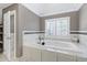 Bright, spacious bathroom with a soaking tub, elegant marble accents, and a stylish open doorway at 225 Midenhall Way, Cary, NC 27513