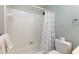 Bathroom featuring a white tiled shower and a toilet with toilet paper at 225 Midenhall Way, Cary, NC 27513