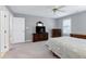 Spacious bedroom featuring gray walls, carpet flooring, traditional furnishings, and a ceiling fan at 225 Midenhall Way, Cary, NC 27513