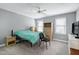 Bedroom with a blue blanket on the bed, a ceiling fan, and carpet floors at 225 Midenhall Way, Cary, NC 27513
