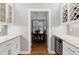 Elegant butler pantry showcasing white cabinets, wine storage, and hardwood floors at 225 Midenhall Way, Cary, NC 27513