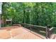 Expansive wooden deck overlooking a lush green backyard and mature trees at 225 Midenhall Way, Cary, NC 27513
