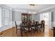 Formal dining room featuring a large table, hardwood floors, and elegant chandelier at 225 Midenhall Way, Cary, NC 27513