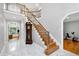 Grand foyer with a staircase, wood floors, a marble entryway, and an exercise room at 225 Midenhall Way, Cary, NC 27513