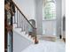 Bright foyer with marble floors, a staircase, and a large window above the front door at 225 Midenhall Way, Cary, NC 27513