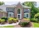 Charming brick home features a symmetrical facade, mature landscaping, a walkway, and a classic front door at 225 Midenhall Way, Cary, NC 27513