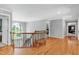 Bright upstairs hallway with wood floors, wood railing and banisters and a large arched window at 225 Midenhall Way, Cary, NC 27513